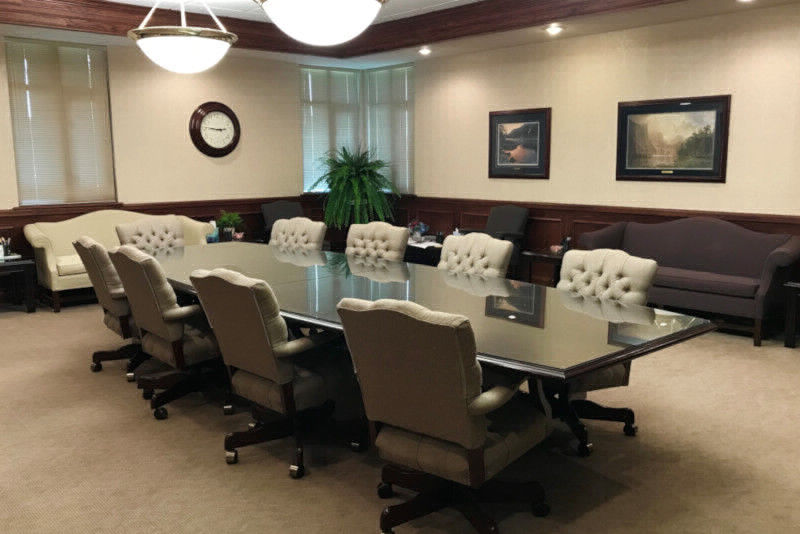 M & A Electric Power Cooperative Board Room photo showing table and chairs with clock and pictures on the walls.