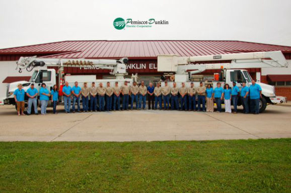 Photo of Pemiscot-Dunklin Electric Cooperative headquarters showing trucks and employees.